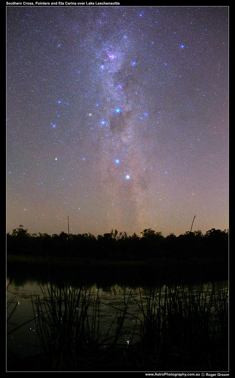 Southern Cross, Pointers and Eta Carina (southern Milky Way) over the shore of Lake Leschenaultia with reads and distant treeline.
